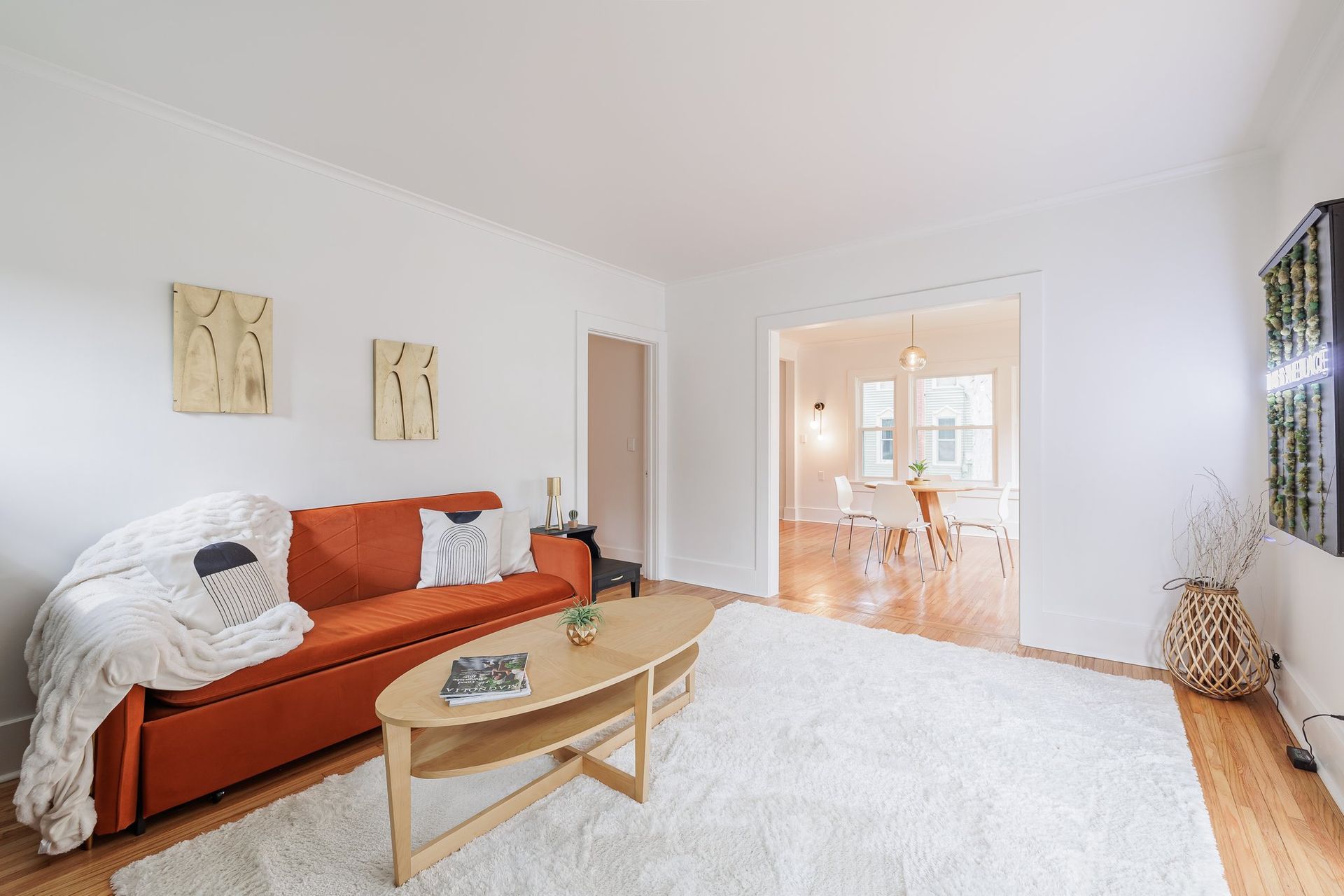 A living room with a couch , coffee table , and rug.