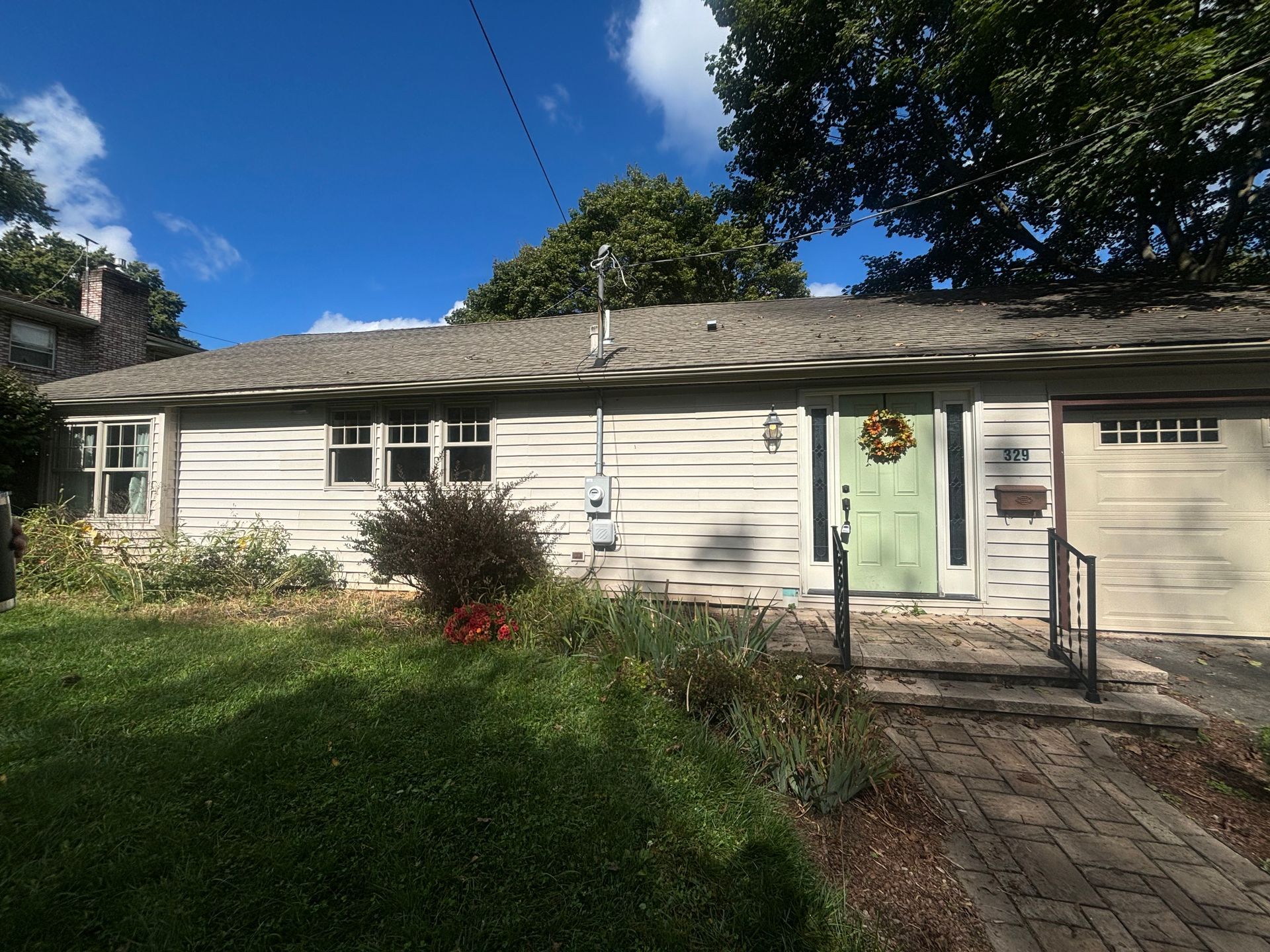 The front of a house with a lot of windows and shutters.