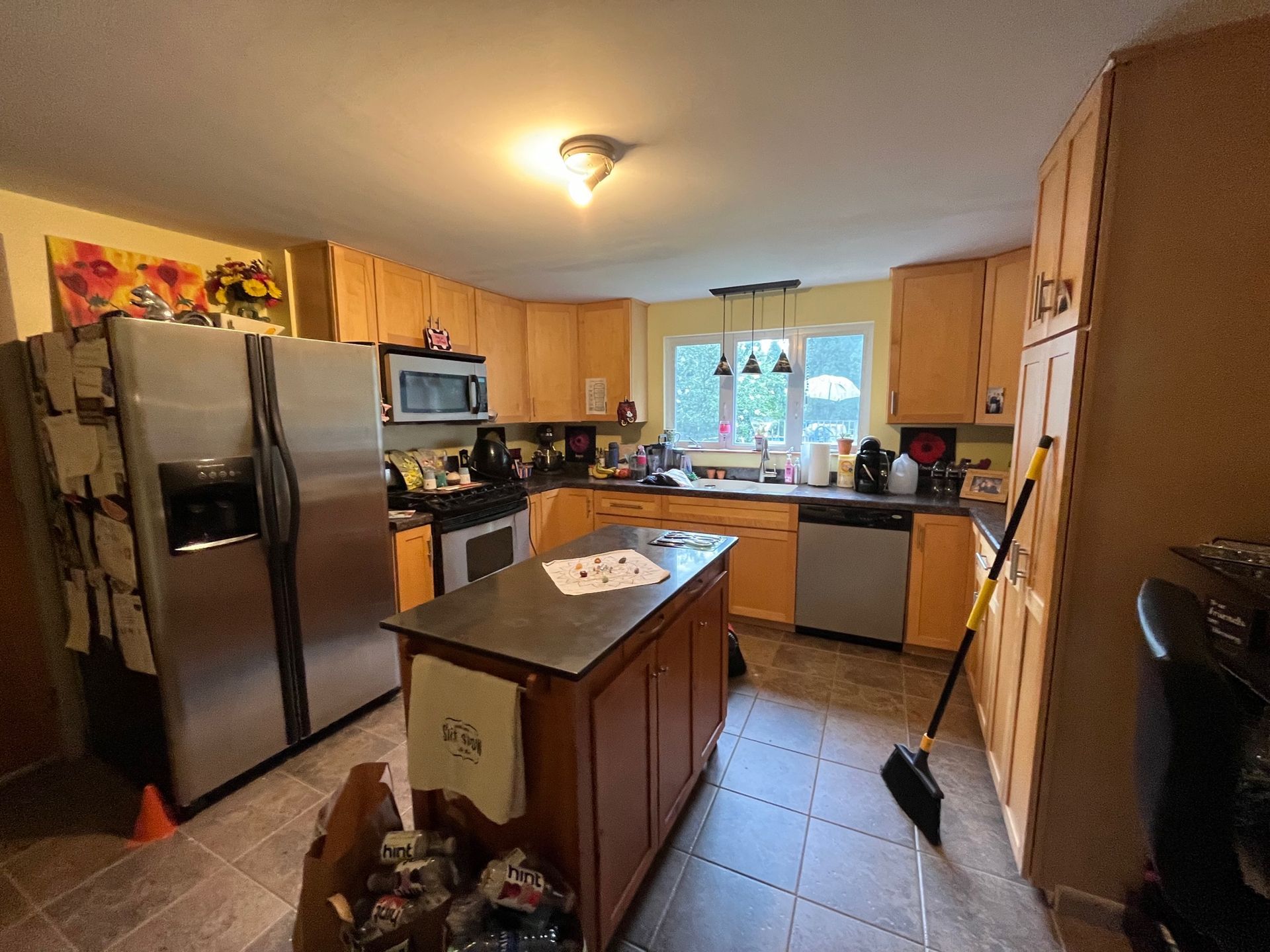 A kitchen with stainless steel appliances and wooden cabinets