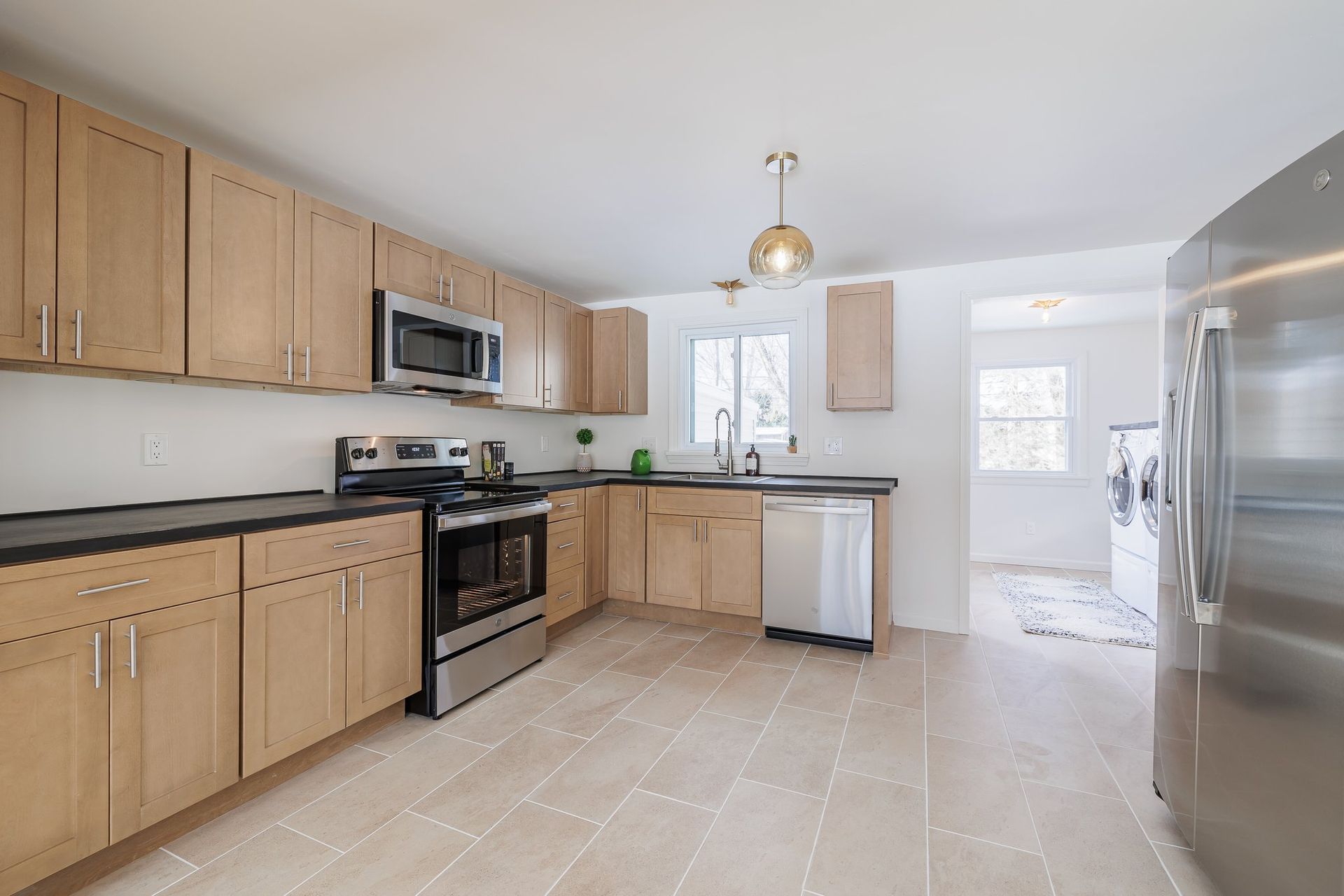 A kitchen with stainless steel appliances and wooden cabinets