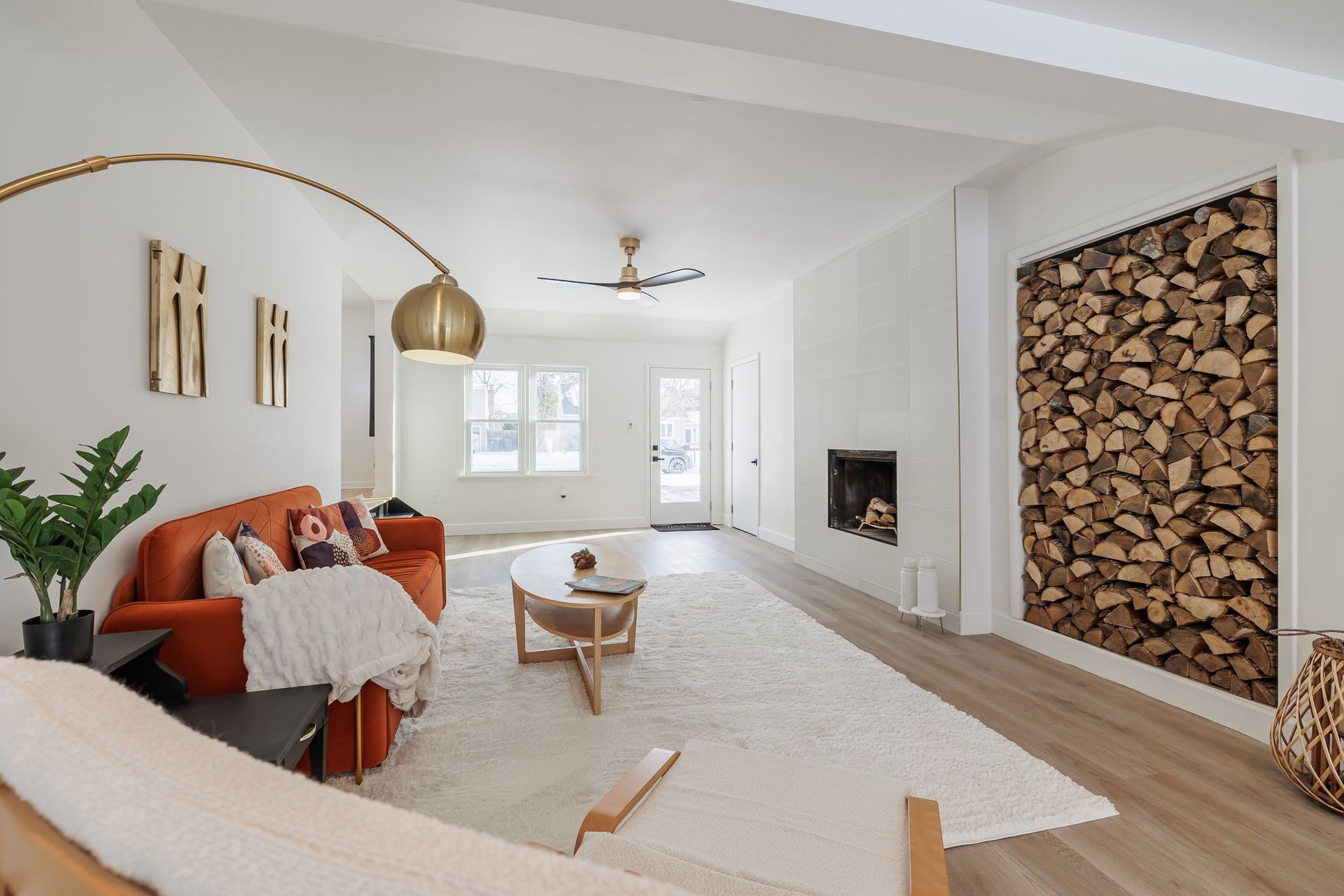 A living room with a couch , coffee table , and fireplace.