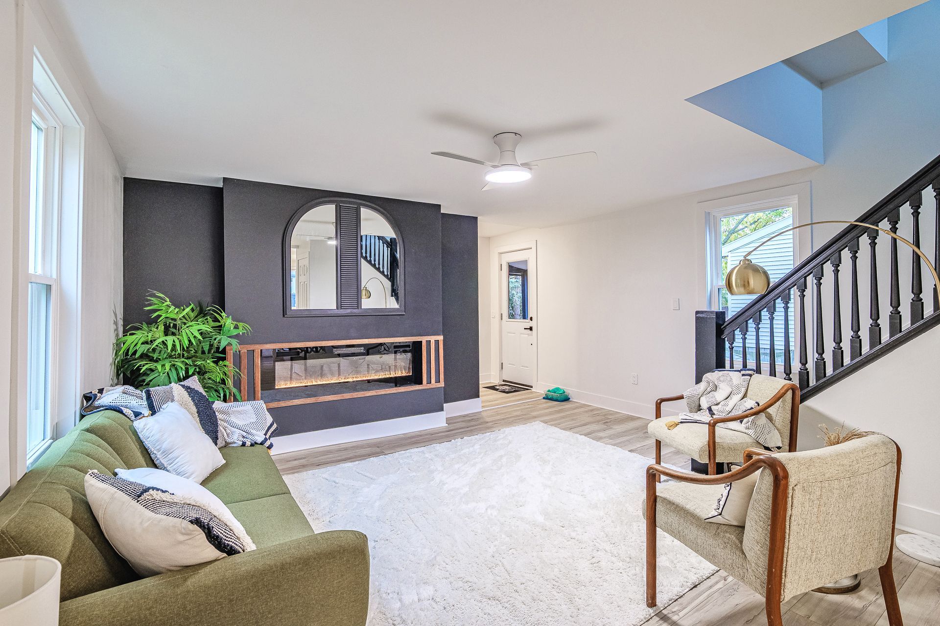 A living room with a couch , coffee table , and rug.