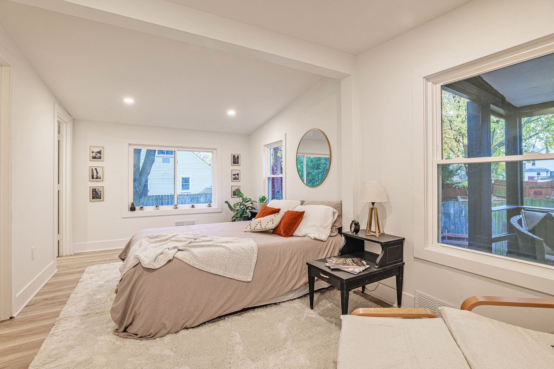 A living room with a couch , table , chair and french doors.
