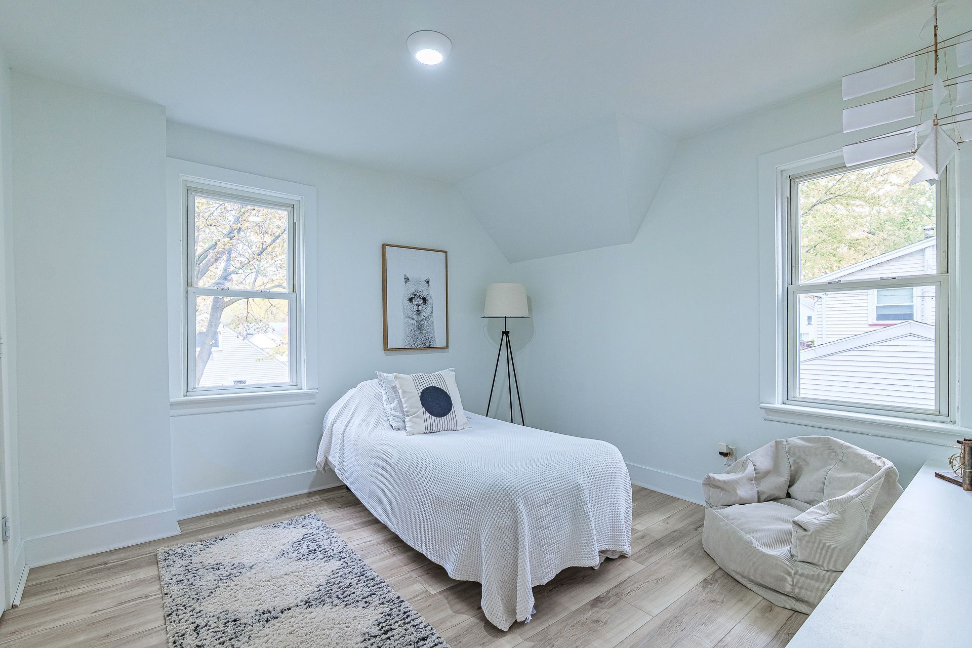 A bathroom with a toilet , sink , shower and mirror.