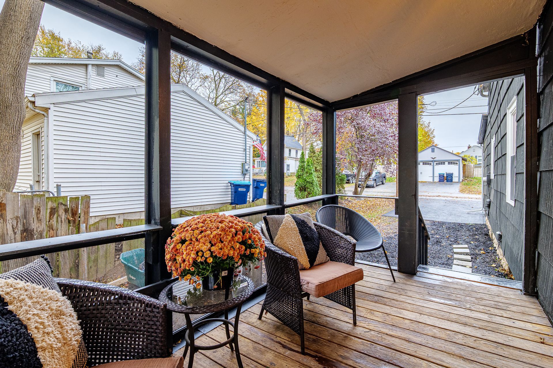 A living room with a couch , coffee table , fireplace and a painting on the wall.