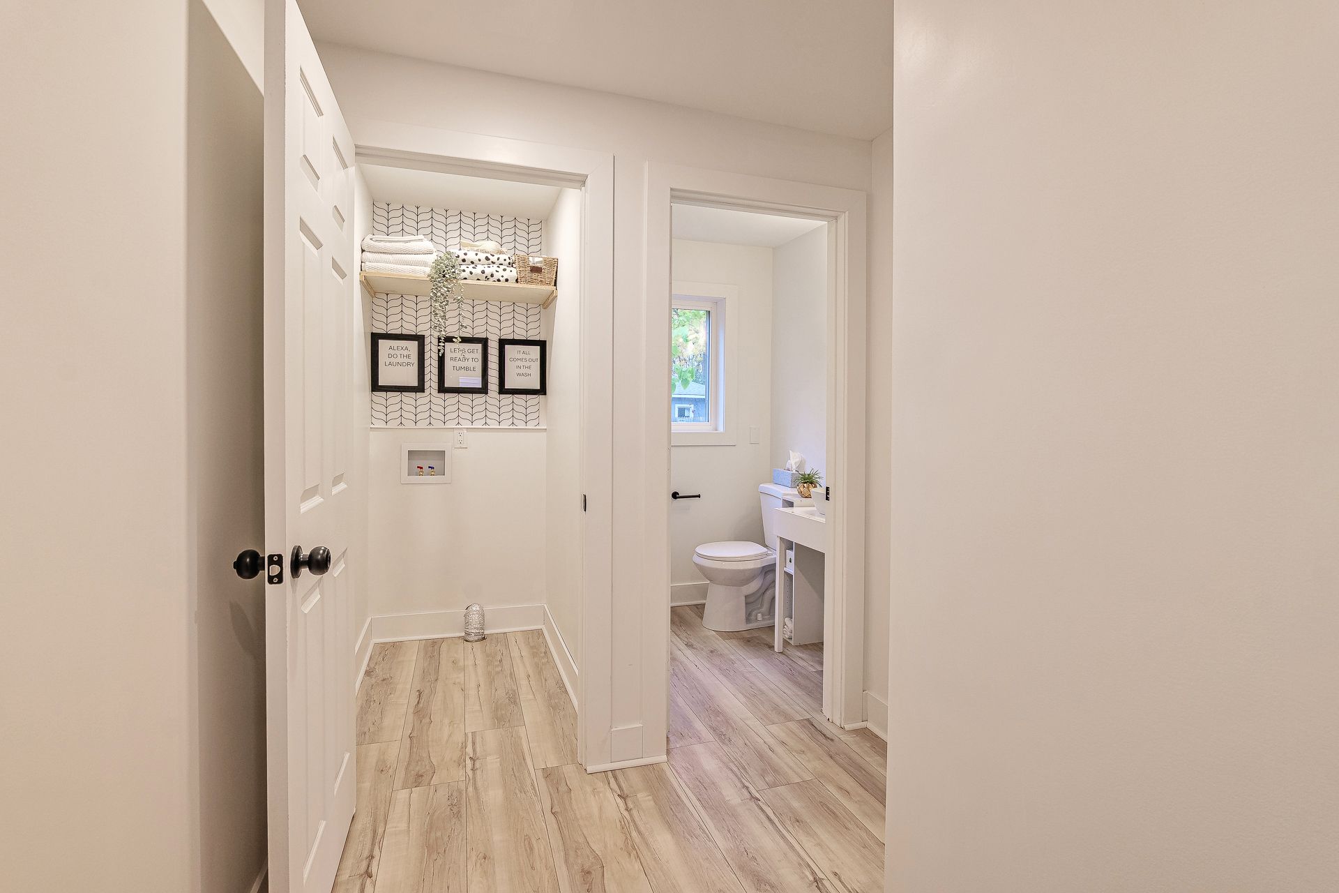 A living room with hardwood floors and lots of windows.