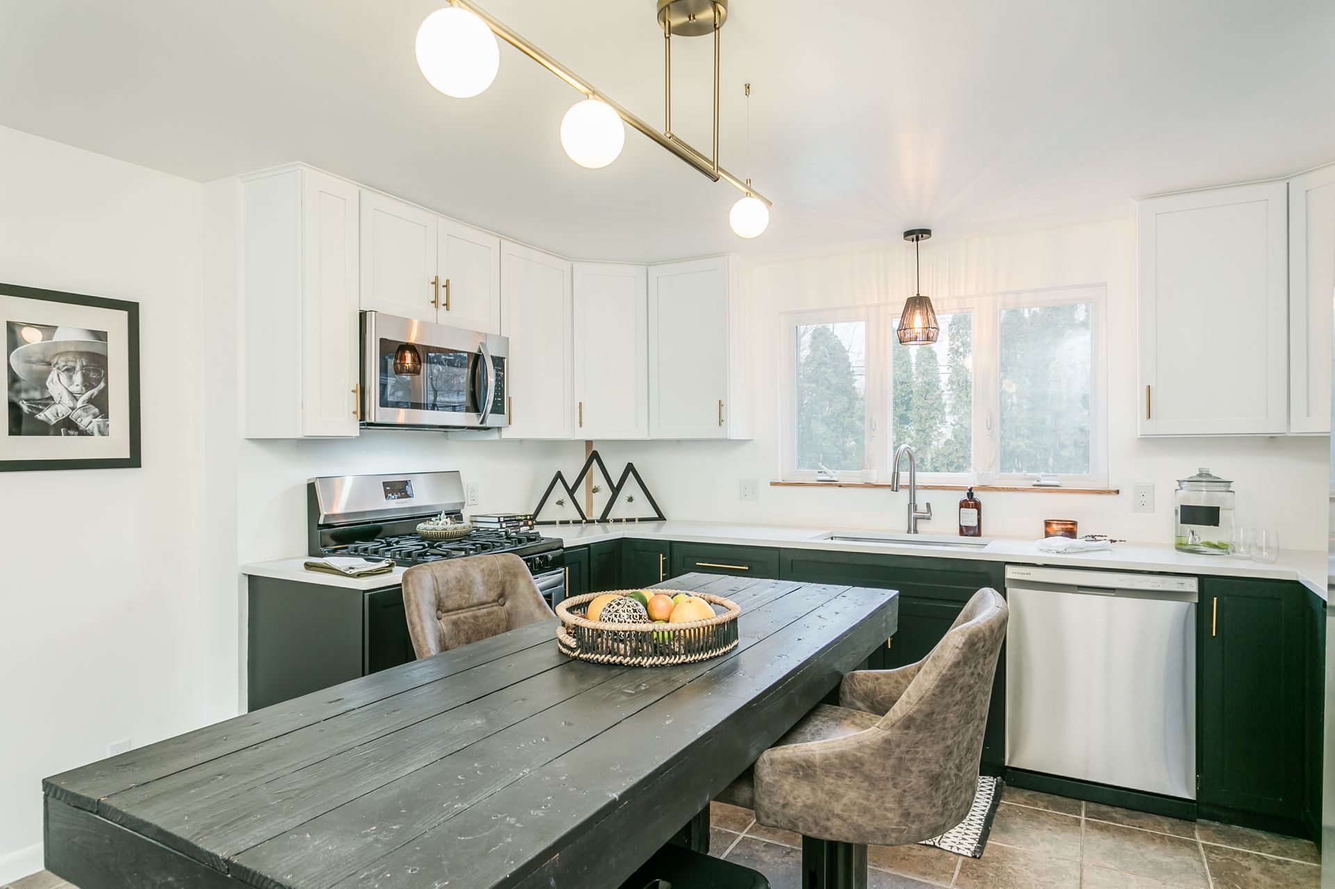 A kitchen with a table and chairs in it