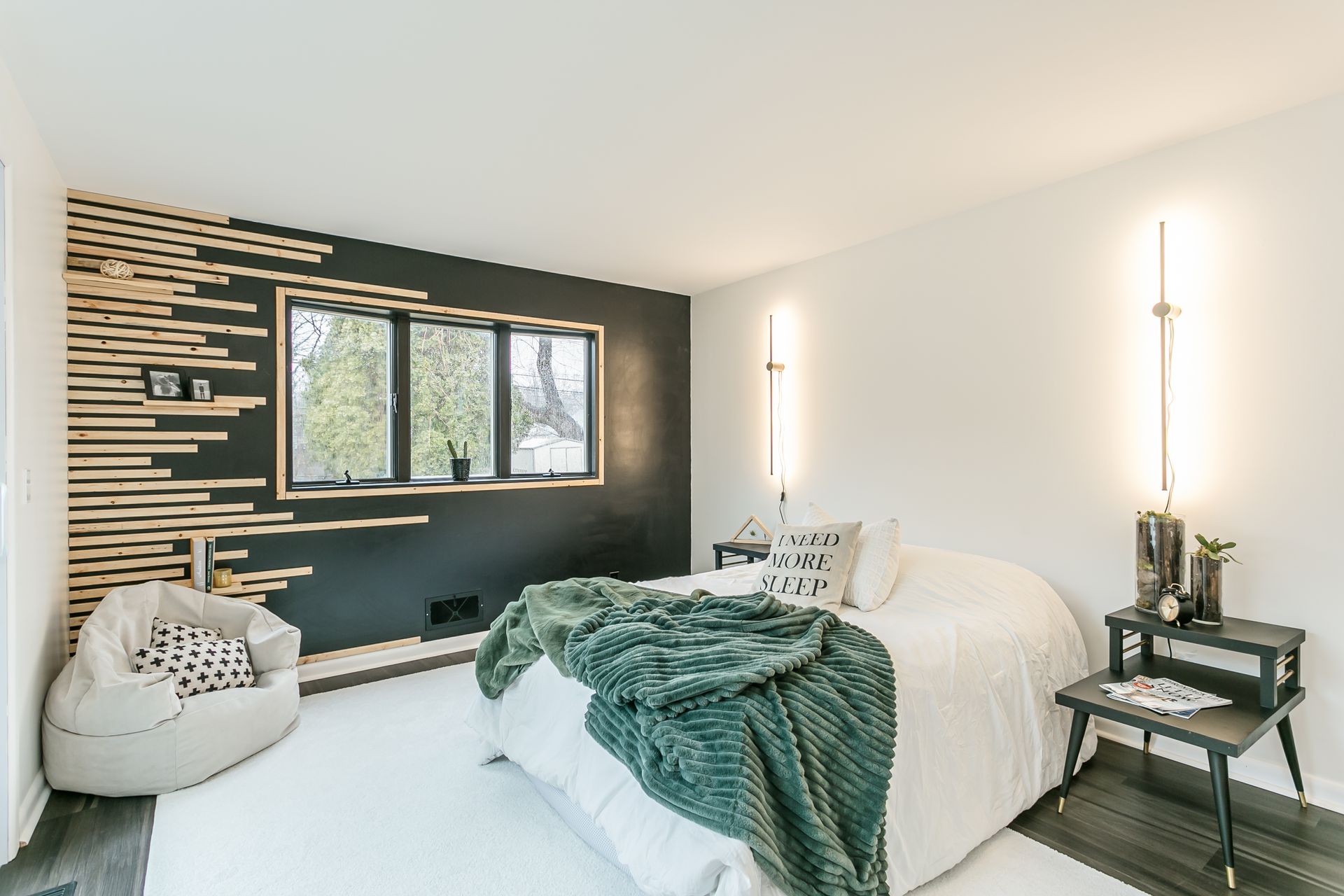 A bedroom with a large bed and a bean bag chair