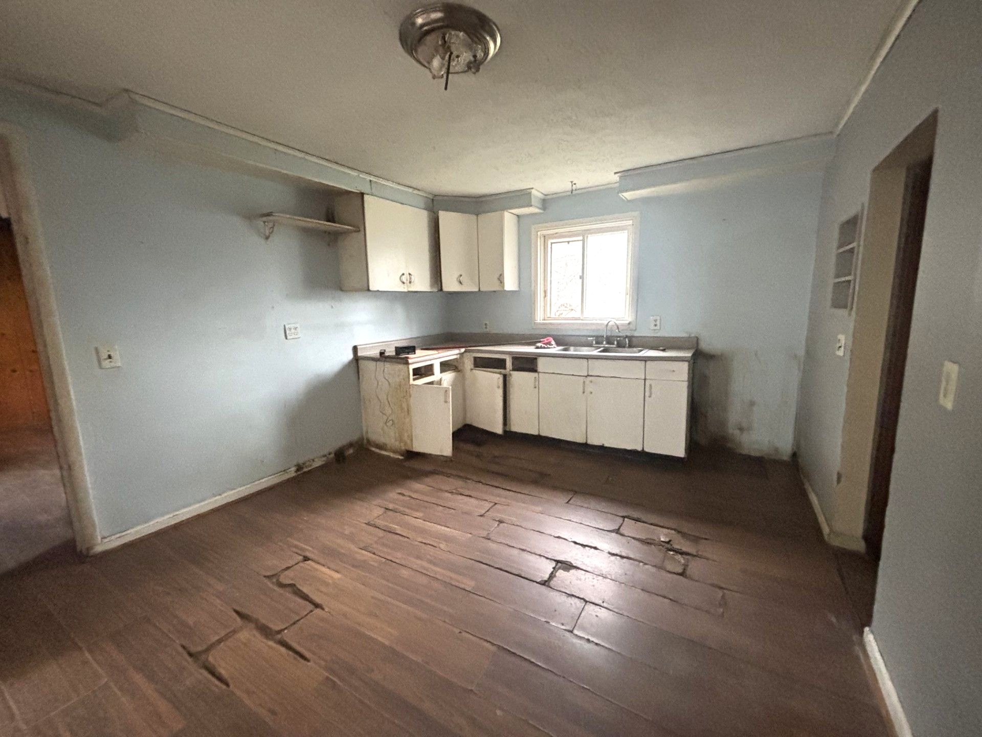 A kitchen with a yellow stove and a pink refrigerator