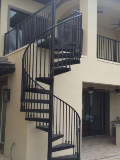 A spiral staircase on the side of a building