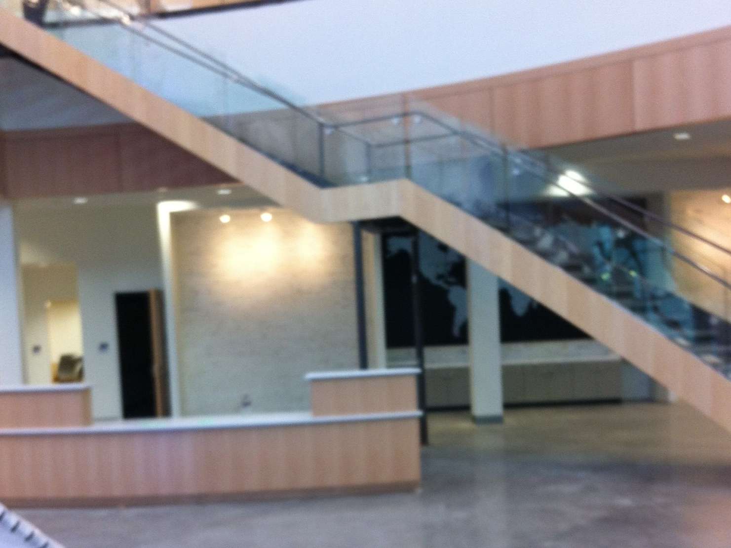 A staircase in a building with a glass railing