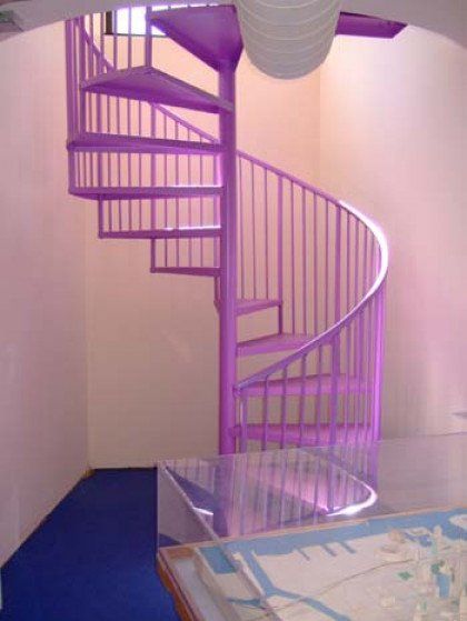 A purple spiral staircase in a pink room
