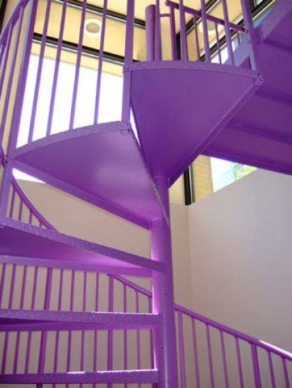 A purple spiral staircase with a purple railing