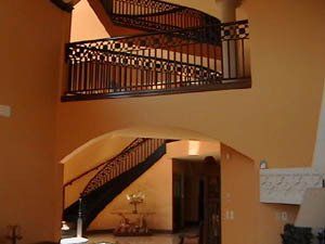A staircase with a wrought iron railing in a house