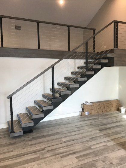An empty room with a staircase leading up to the second floor.