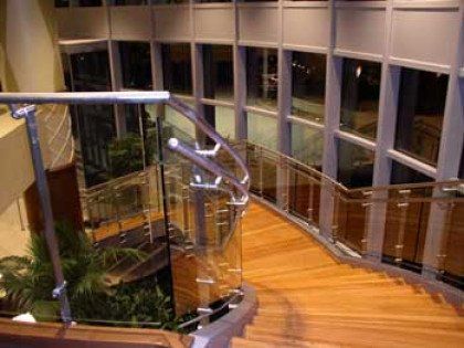 wood stairs with glass and stainless steel railings