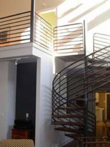 A spiral staircase leading up to the second floor of a house.