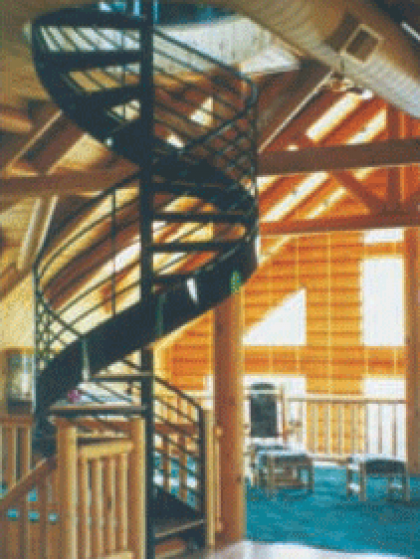 A spiral staircase in a room with wooden beams