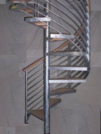 A spiral staircase with a metal railing and wooden steps