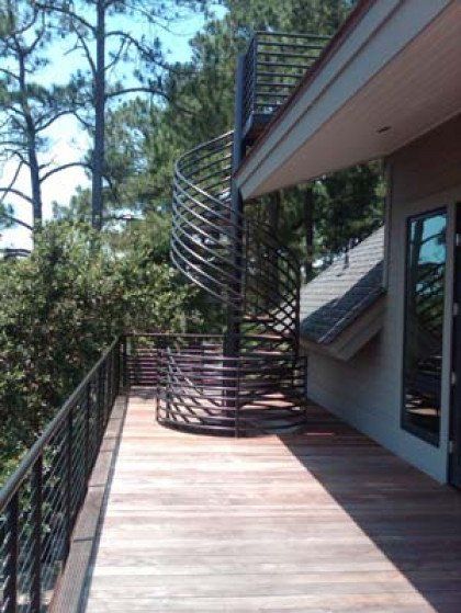 A wooden deck with a spiral staircase on it