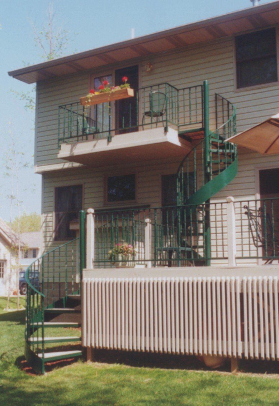 A house with a balcony and stairs leading up to it
