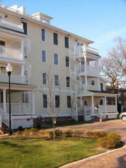 A large white building with stairs on the side of it