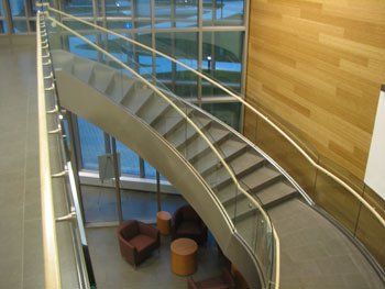 A staircase with a glass railing in a building