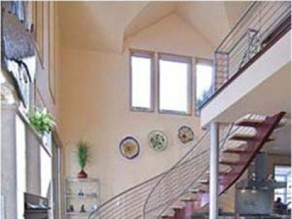 A living room with a staircase leading up to the second floor