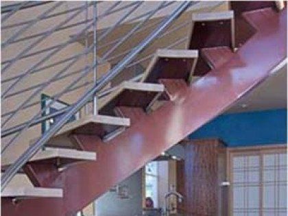 A red staircase with a metal railing in a room.
