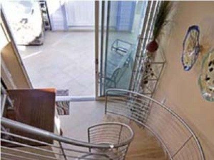 A spiral staircase in a house with a sliding glass door