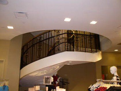 A store with a spiral staircase leading to the second floor.
