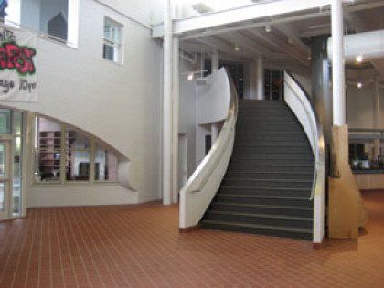 A building with stairs and a sign that says ' r & r ' on it