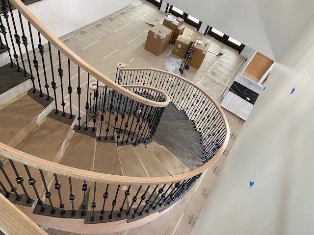 An aerial view of a spiral staircase in a house under construction.