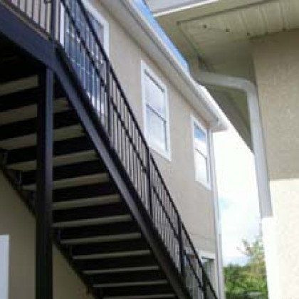 A building with stairs leading up to it and a balcony.