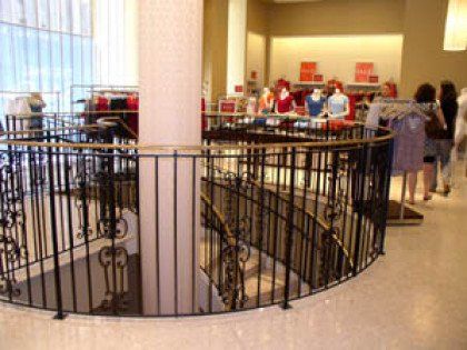 A store with a spiral staircase and a wrought iron railing