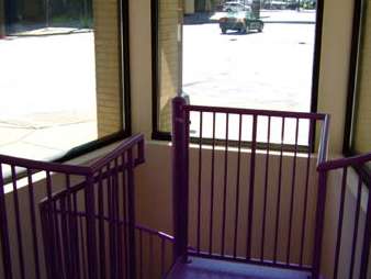 A purple staircase with a purple railing and a window