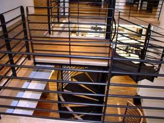 An aerial view of a spiral staircase with a metal railing.