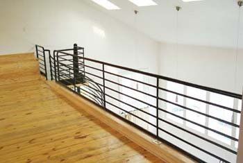 A view of a balcony from the second floor of a house.
