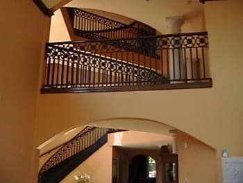 A staircase with a wrought iron railing in a house