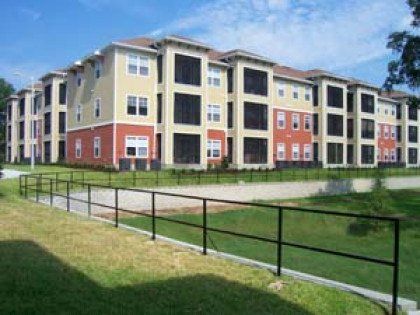 A large apartment building with a fence in front of it