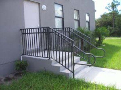 A building with stairs and a railing in front of it