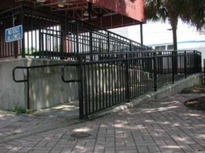 A ramp with a railing and a sign that says no dogs allowed