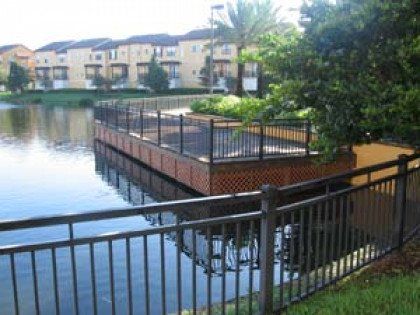 A fence surrounds a small island in the middle of a lake.