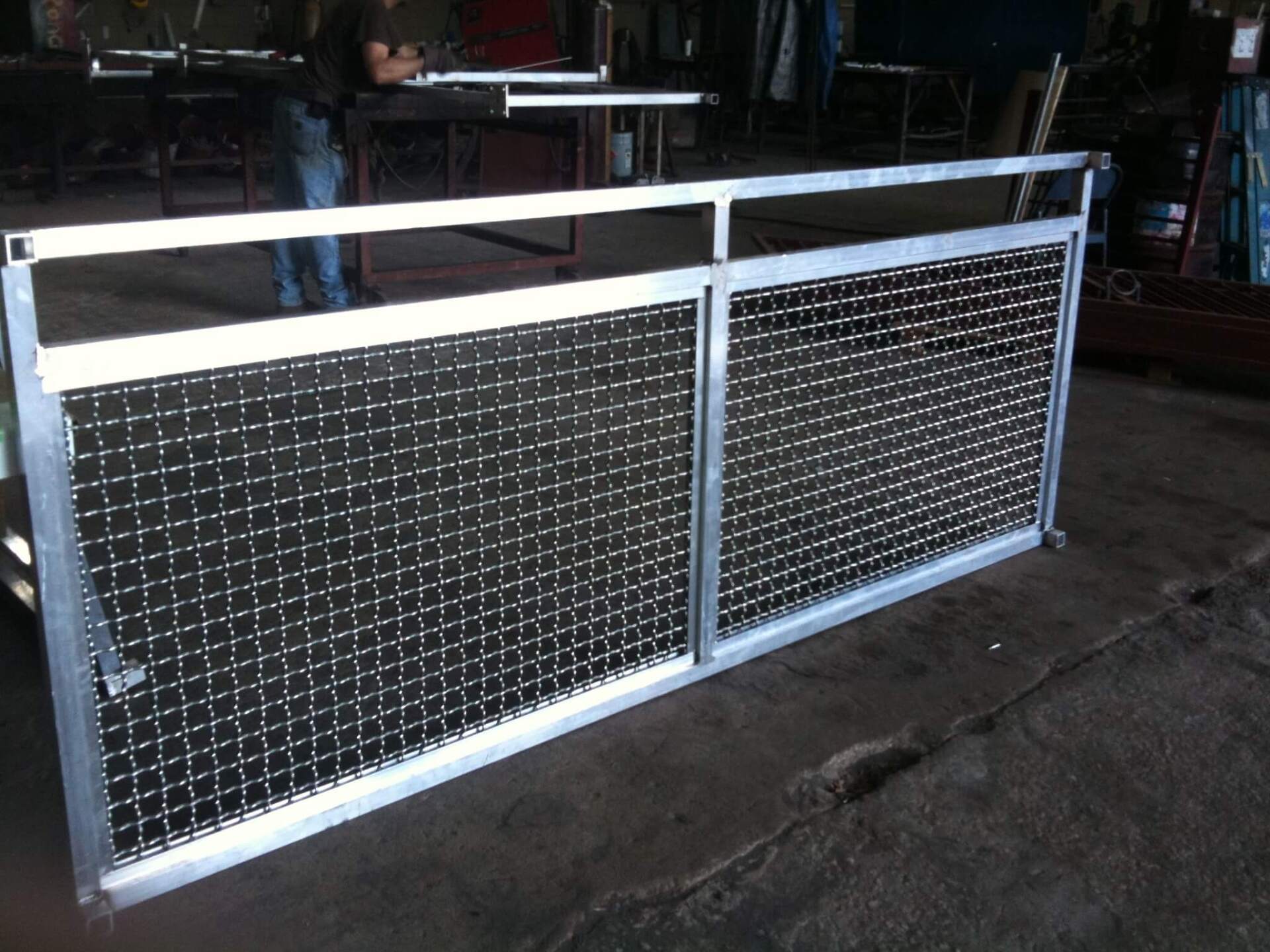 A metal fence is sitting on the ground in a dark room