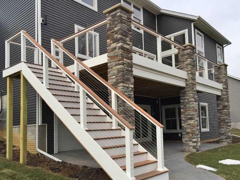 A house with a deck and stairs leading up to it