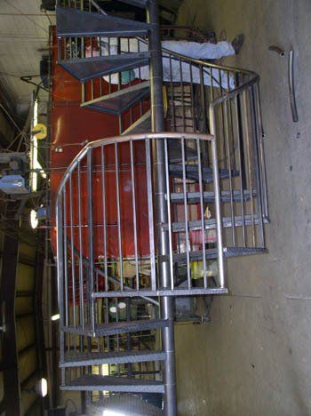 A spiral staircase is being built in a factory