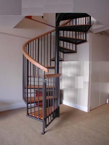 A spiral staircase with wooden steps in a room