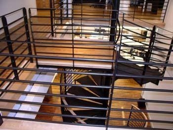 An aerial view of a spiral staircase with a black railing