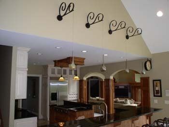 A kitchen with a vaulted ceiling and a bar.