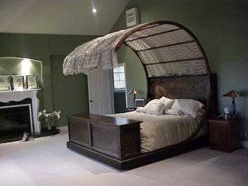 A bedroom with a canopy bed and a fireplace